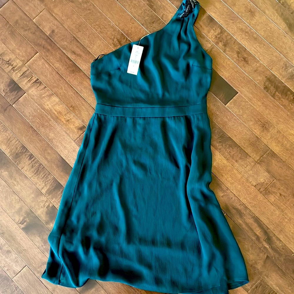Beautiful dark green one shoulder dress with beading detail. New with tags!